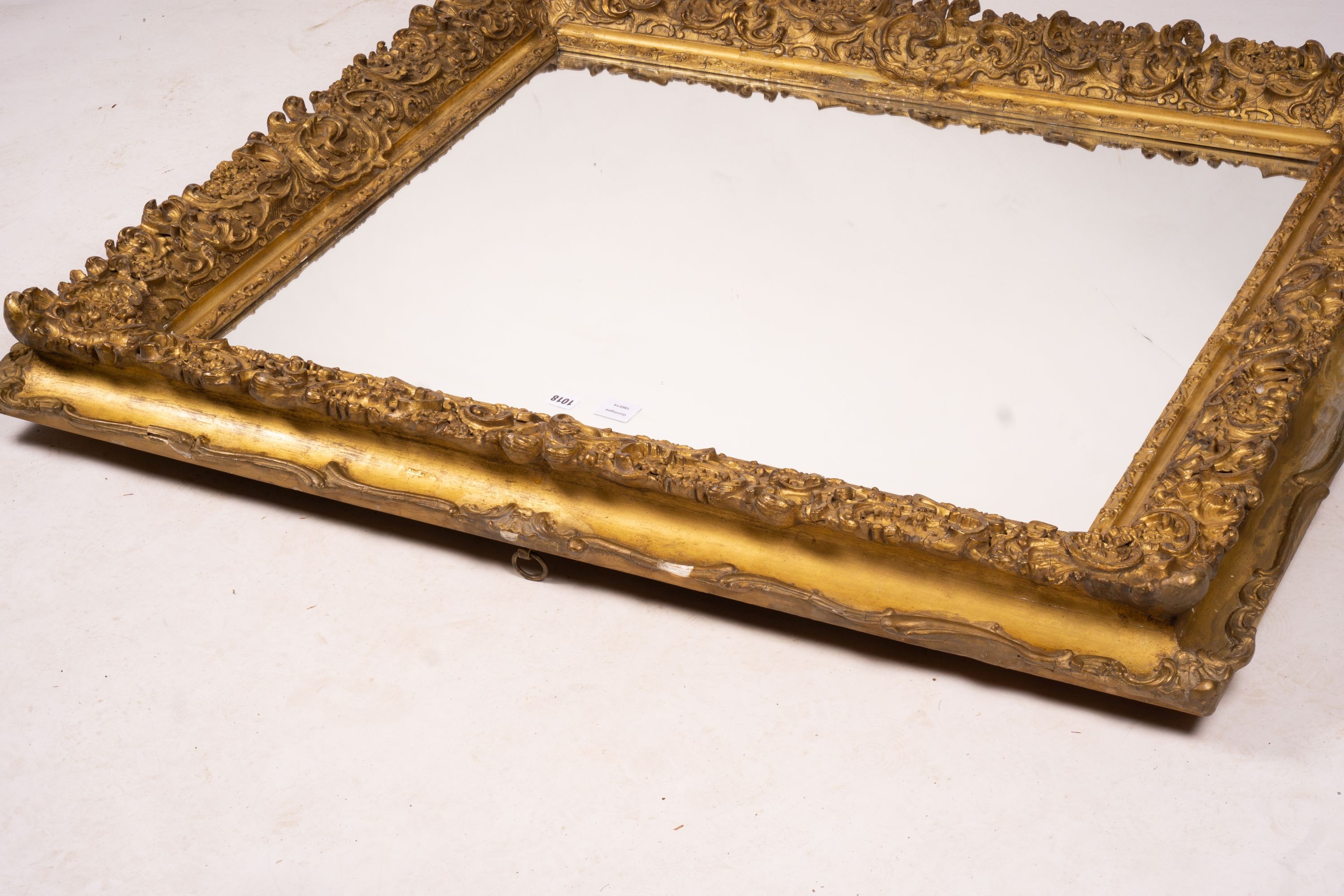 An ornate Victorian giltwood and gesso rectangular wall mirror (formerly a picture frame) width 130cm, height 112cm